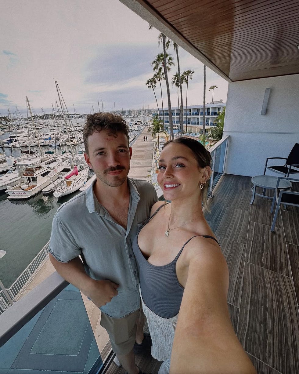 selfie taken on a balcony overlooking a marina