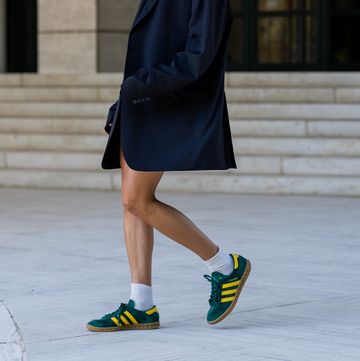 amsterdam, netherlands august 23 model vera van erp wears navy oversized blazer vintage, tank top a modern object, black shorts skall, shoes adidas, white socks during a street style shoot on august 23, 2022 in amsterdam, netherlands photo by christian vieriggetty images