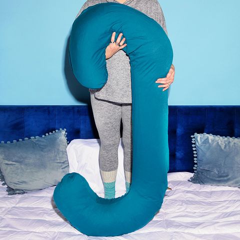 woman holding snoogle pregnancy pillow