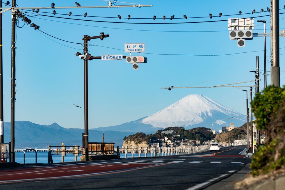 snow capped mt fuji and coast road in kanagawa prefecture of japan