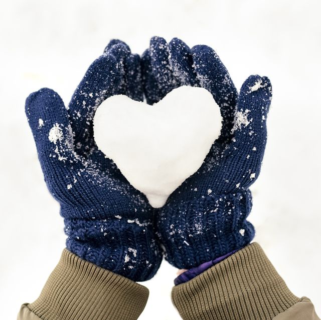 Snow heart on hands with gloves