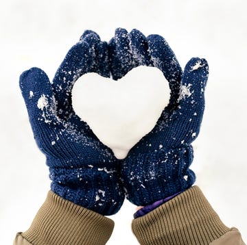 Snow heart on hands with gloves Snow heart on hands with gloves