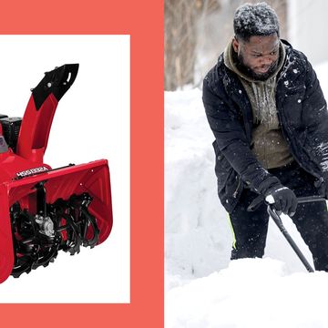 a man pushing a snow blower