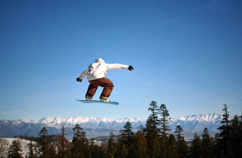 snowboarder jumping at mammoth mountain resort