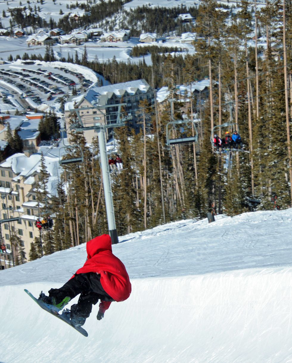 best ski resorts big sky kid snowboarding in red hoodie
