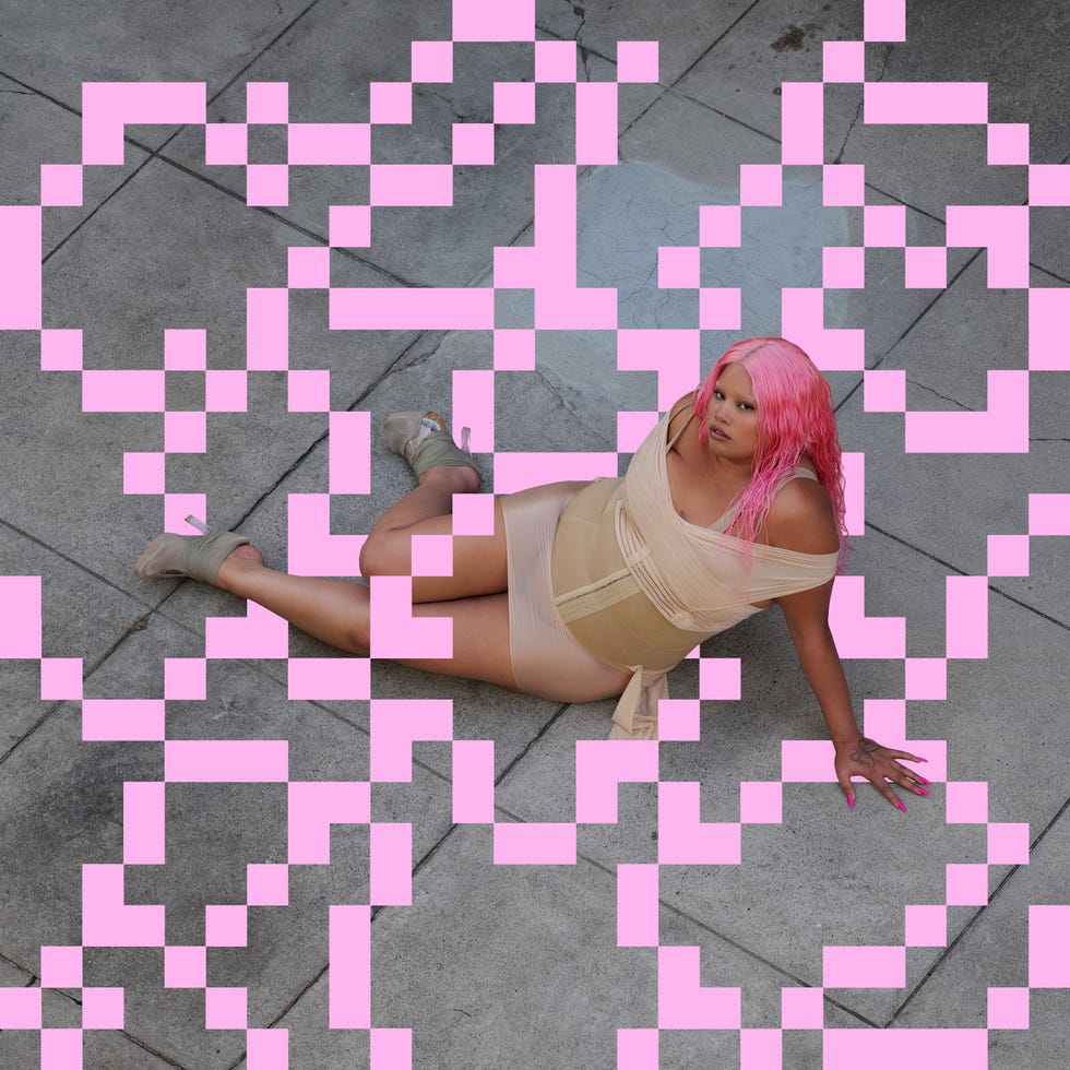 a person poses against a patterned background while sitting a person poses against a patterned background while sitting