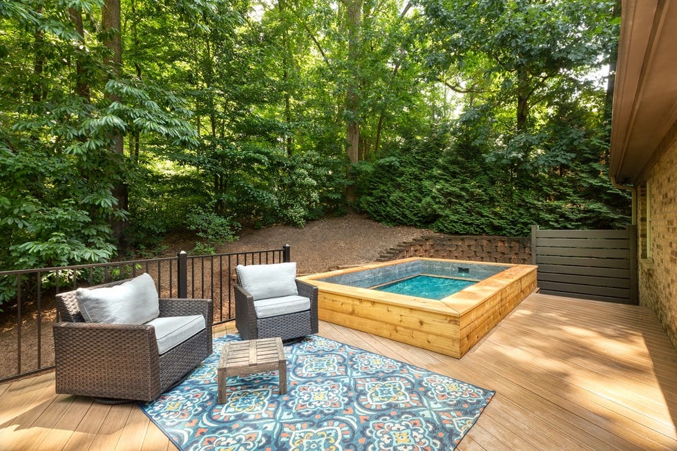 a deck with a pool and chairs