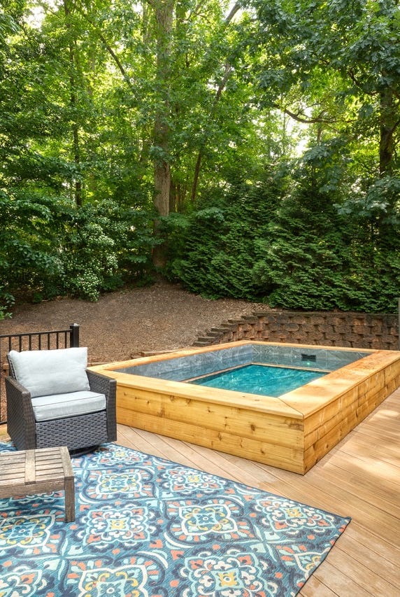 a deck with a pool and chairs a deck with a pool and chairs