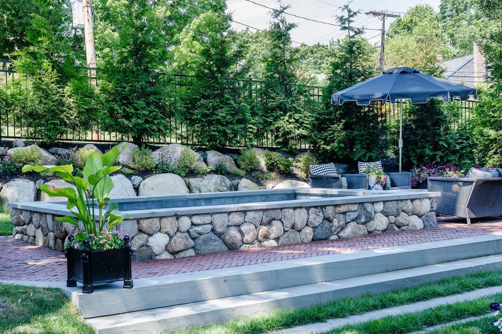 a stone fountain with umbrellas