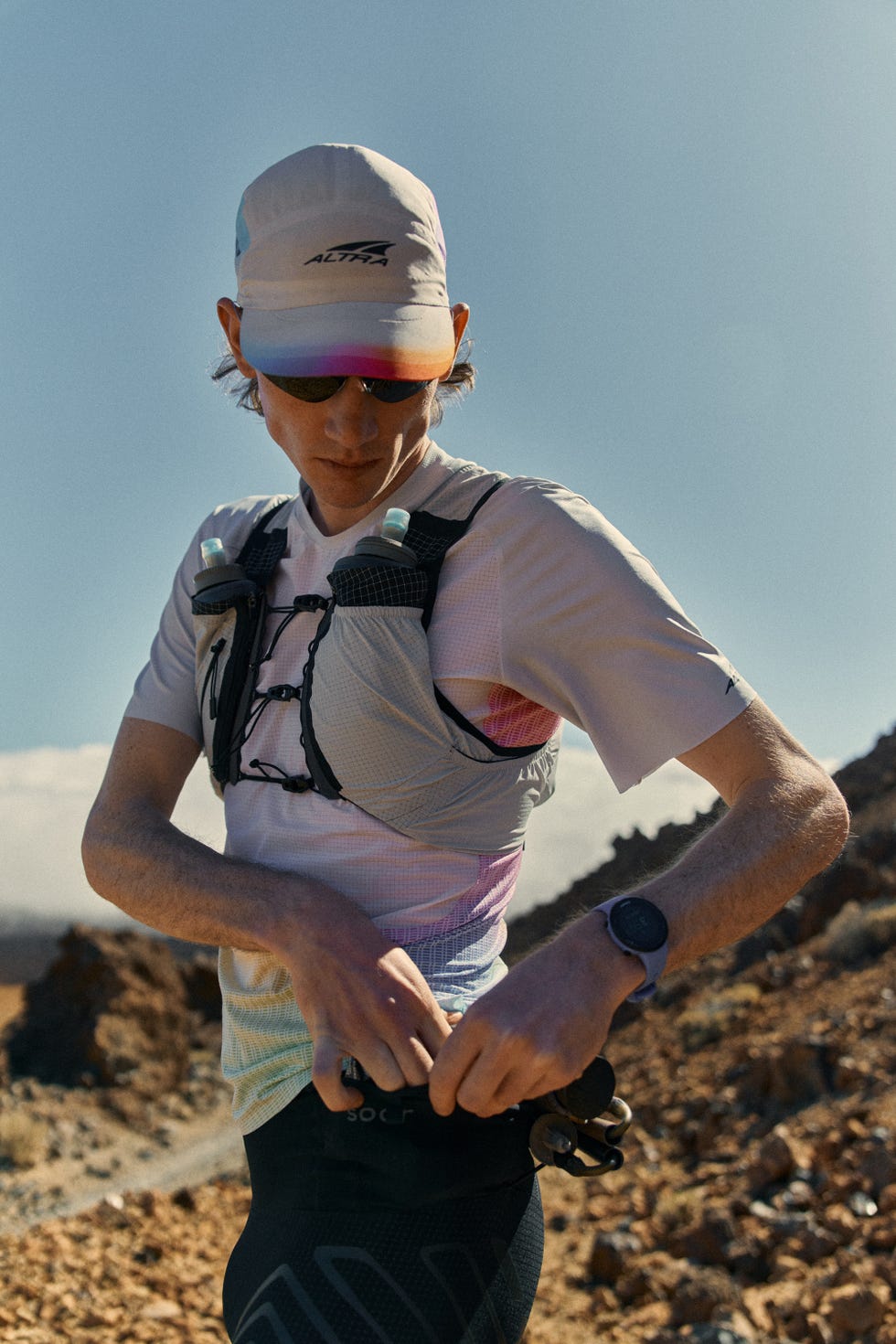a person adjusting a running vest while outdoors