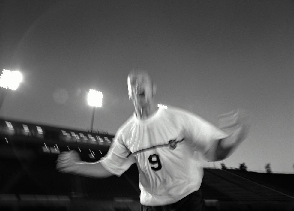 Soccer player screaming, blurred motion (B&W)