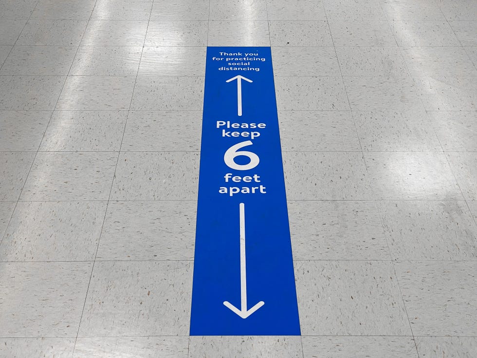social distancing floor sign warning about safe distance between people of 6 feet public health measure to prevent further spread of new corona virus covid 19 infections