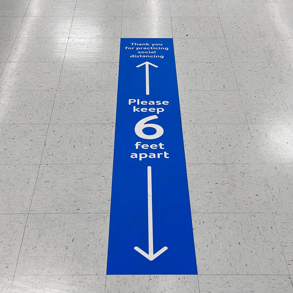 Social distancing floor sign warning about safe distance between people of 6 feet. Public health measure to prevent further spread of new corona virus Covid-19 infections. social distancing floor sign warning about safe distance between people of 6 feet public health measure to prevent further spread of new corona virus covid 19 infections