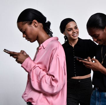FASHION-ITALY-WOMEN-PHILOSOPHY-SERAFINI models check their mobile phone as they wait in the backstage before the philosophy di lorenzo serafini fashion show, as part of the womens springsummer 2019 fashion week in milan, on september 22, 2018 photo by marco bertorello afp photo credit should read marco bertorelloafp via getty images