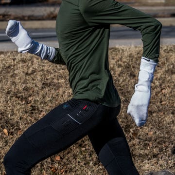 person running outdoors wearing athletic attire and makeshift mittens person running outdoors wearing athletic attire and makeshift mittens