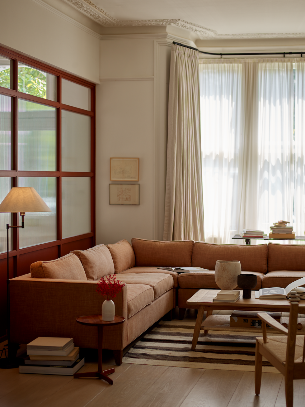 Red corner sofa in a cream-colored living room