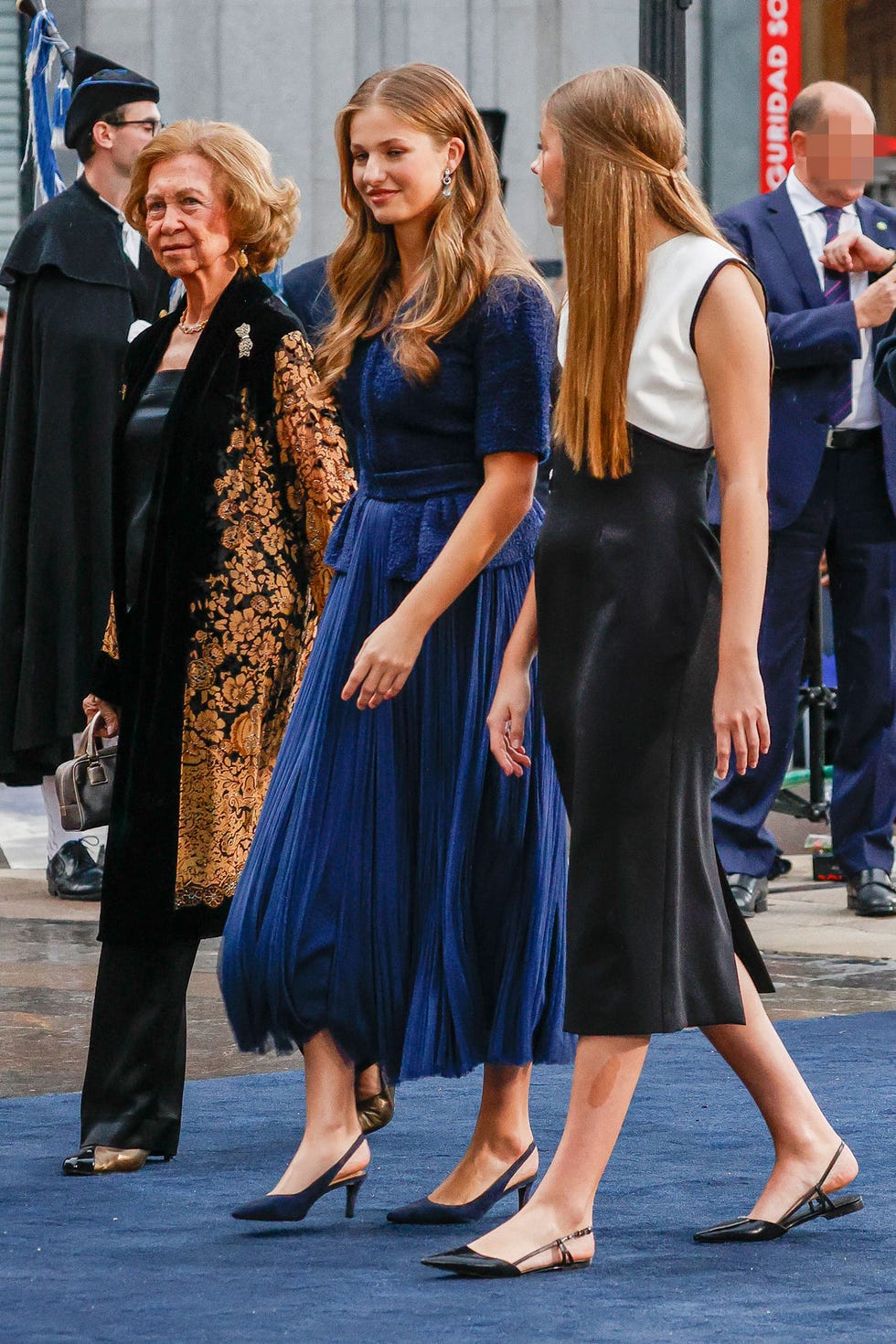 a group of women in dresses