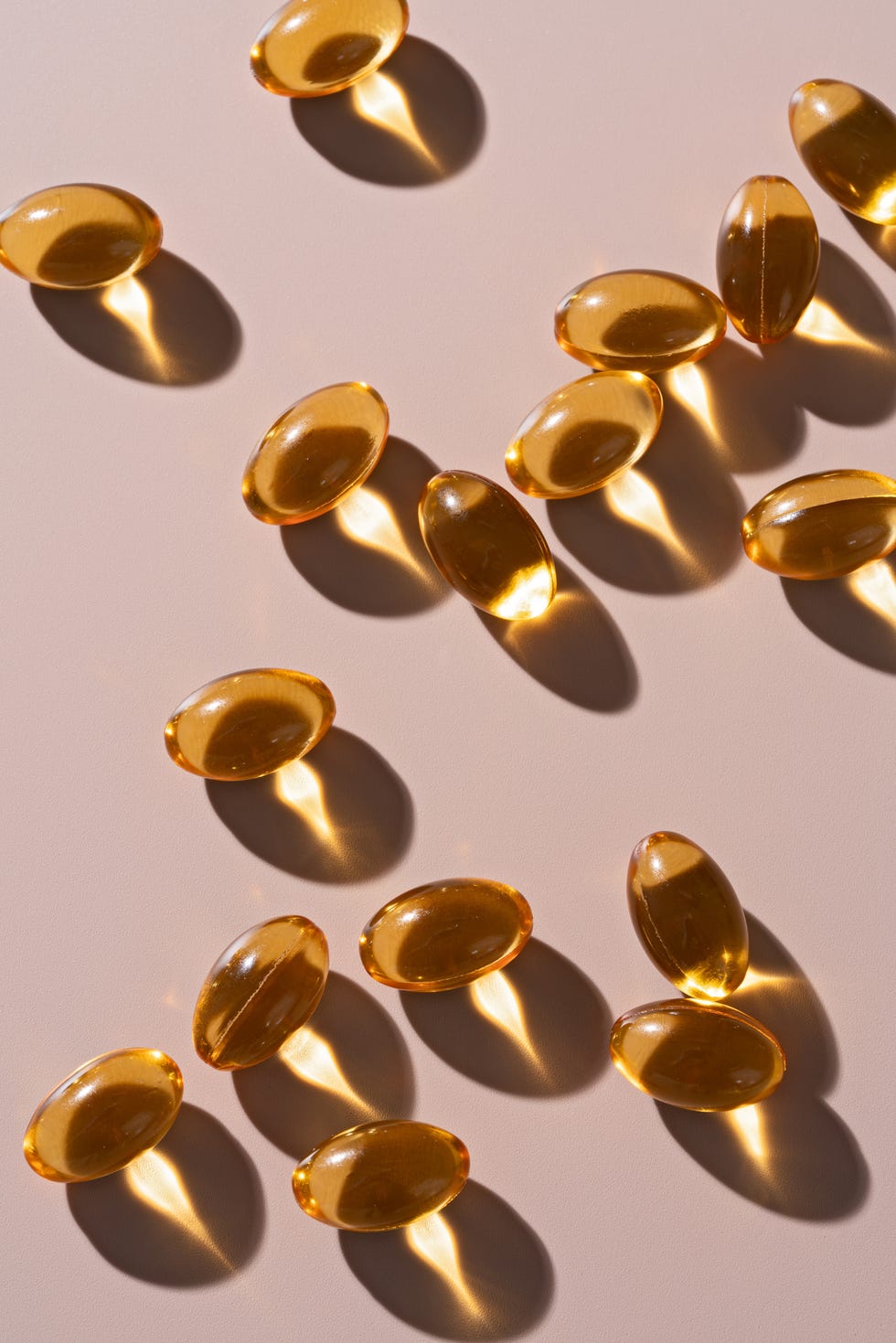 soft capsules of fish oil on beige background