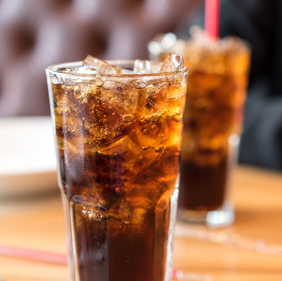 Soft drink on wooden table and men sitting Soft drink on wooden table and men sitting