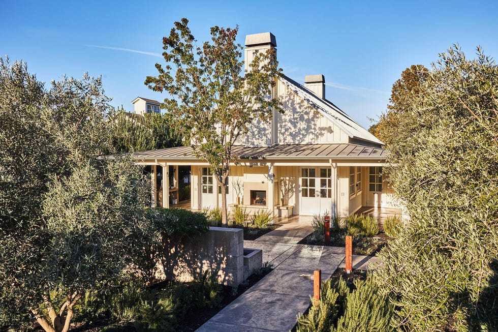 a house with trees and bushes around it