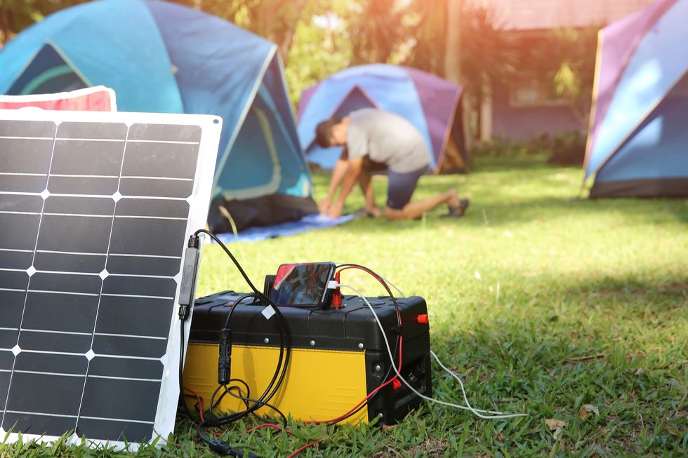 solar panel charging mobile phone on grass
