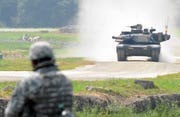 a us soldier looks at a m1a2 sep abrams