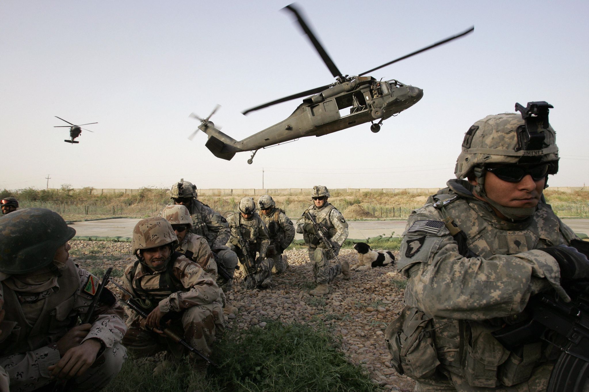 us and iraqi soldiers ﻿protect themselves from dust kicked up by two us blackhawk helicopters carrying the first group for an air assault in al rudwaniyah on the southwest edge of baghdad on may 2 2008