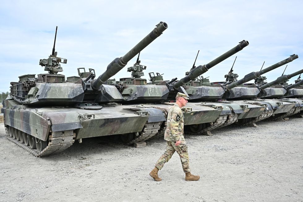 https://hips.hearstapps.com/hmg-prod/images/soldier-of-the-us-army-1st-raider-brigade-walks-past-tanks-news-photo-1674769745.jpg?resize=980:*