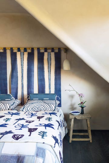 bed dressed in shibori fabric with fabric headboard