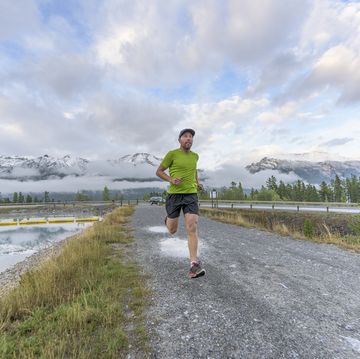 solitary runner follows mountain path, after rain