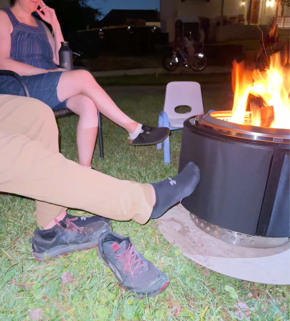 socked foot on solo stove screen