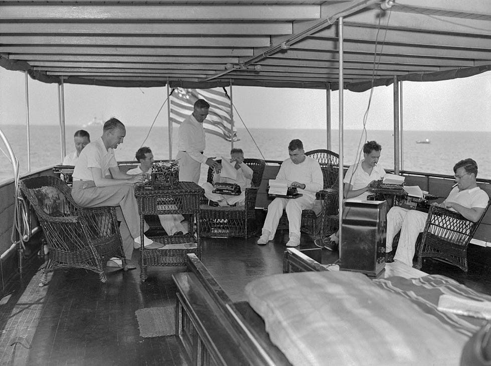 reporters typing stories on ship deck