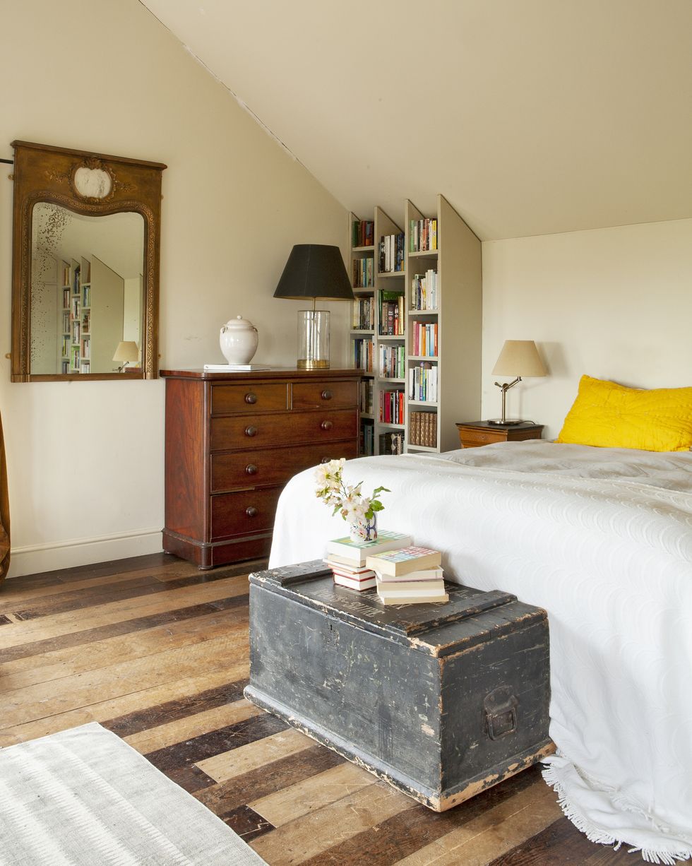 bedroom with bed chest of drawers and vintage trunk