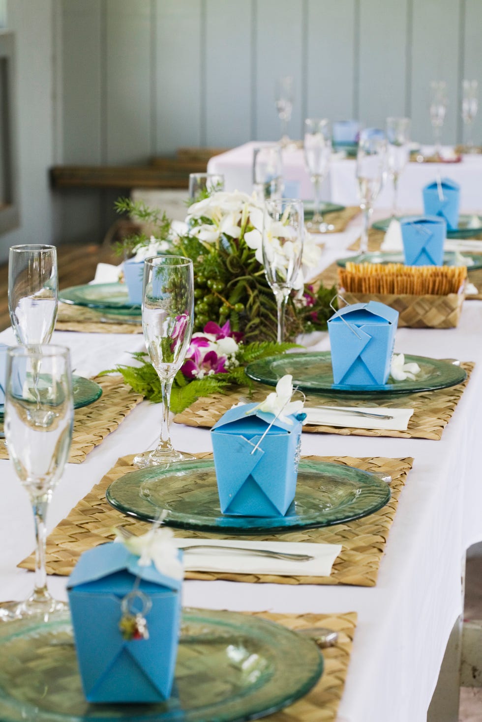wedding table setting with blue boxes set up and wrapped on each individual plate
