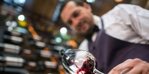 sommelier pouring a glass of wine