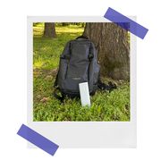 sonos roam speaker near backpack in the woods