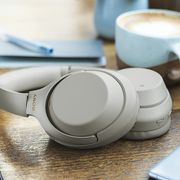 sony headphones on counter with coffee and phone
