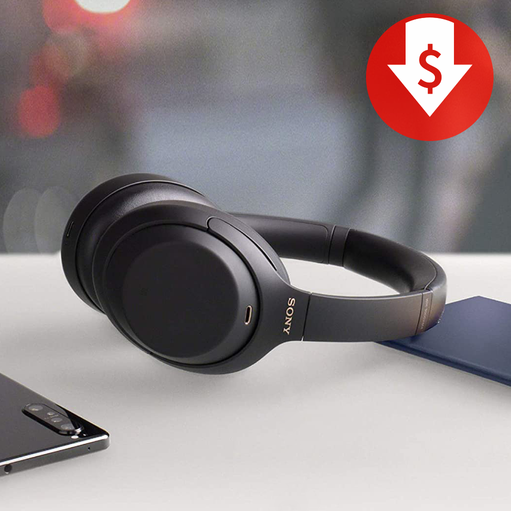 sony noise canceling headphones on table with phone and passport