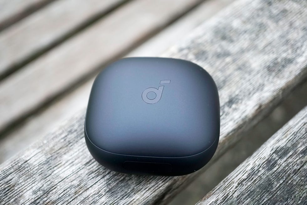 soundcore liberty 4 pro wireless earbuds charging case on a wooden surface