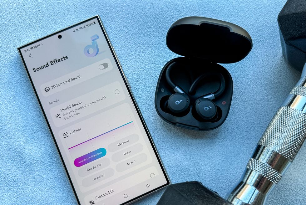 soundcore sport x20 wireless earbuds next to a phone with the soundcore app