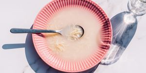 soup in a pink dish with shadows and noodles pasta