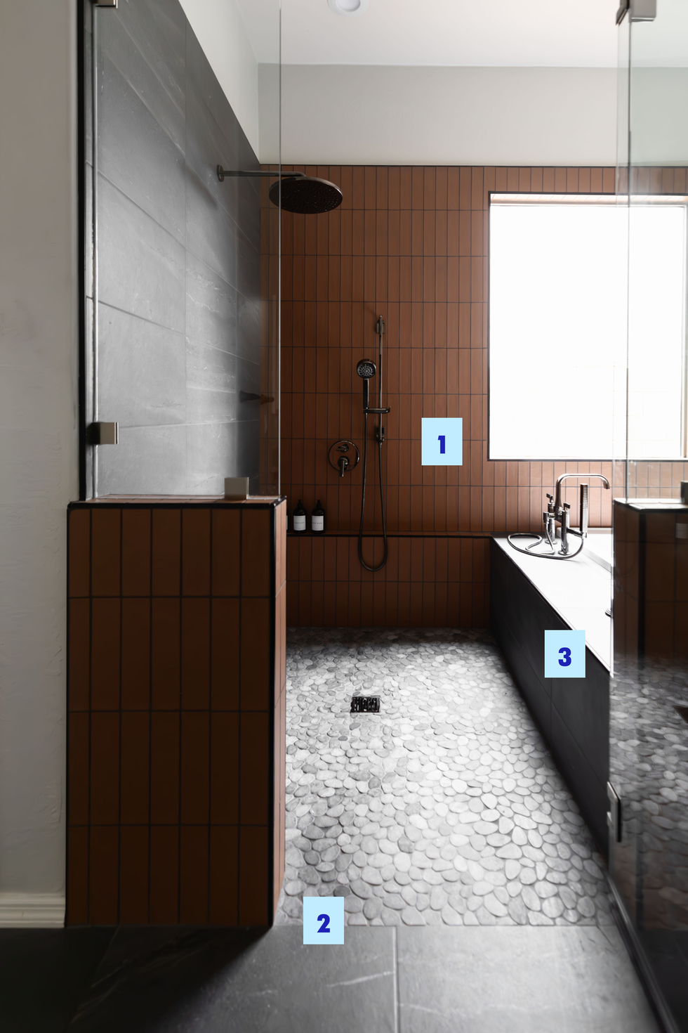 accessible bathroom with stone floor and seamless curb entry