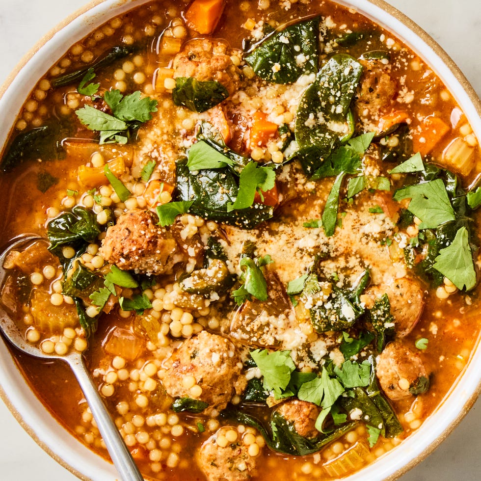 Southwestern Wedding Soup a bowl of soup with pasta, meatballs, spinach, cilantro, and cotija cheese