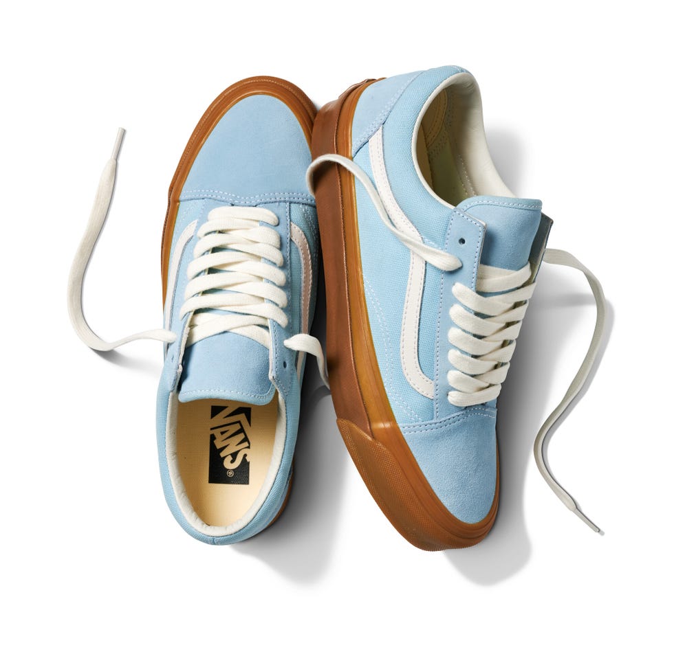 blue sneakers with white laces and a gum sole