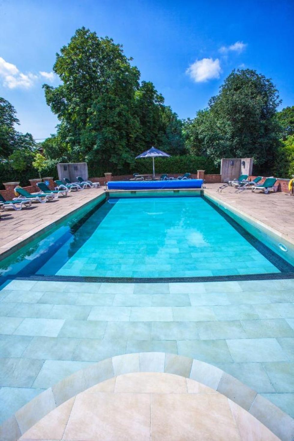 a pool with chairs around it