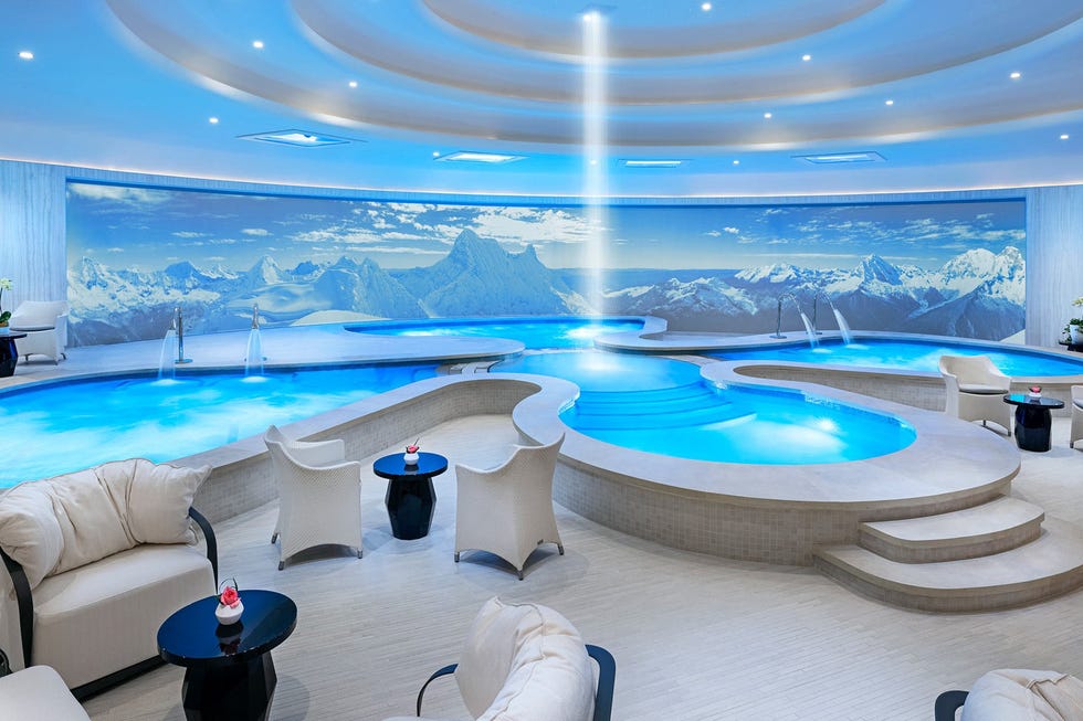 relaxation area featuring multiple pools and a scenic mountain backdrop relaxation area featuring multiple pools and a scenic mountain backdrop