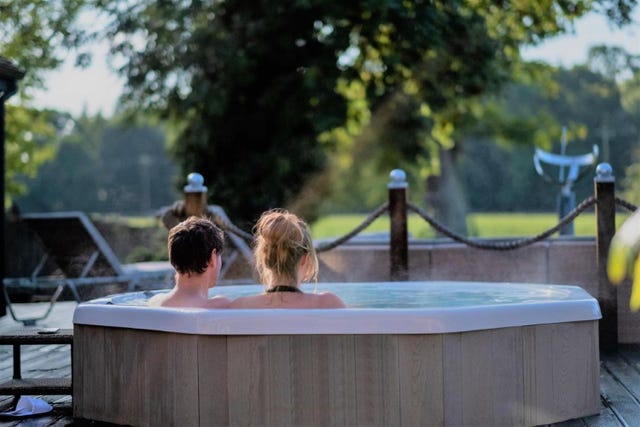 a couple sitting in a hot tub