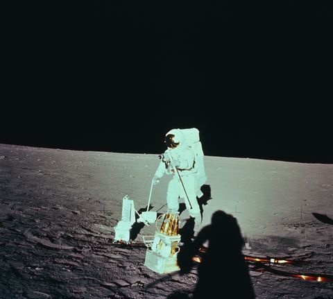 astronaut deploying an apollo lunar surface experiments package