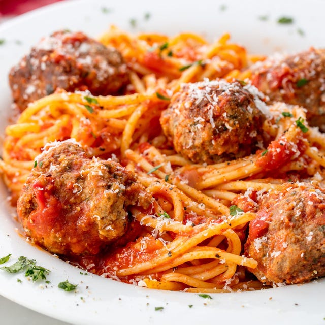 spaghetti and meatballs topped with parmesan