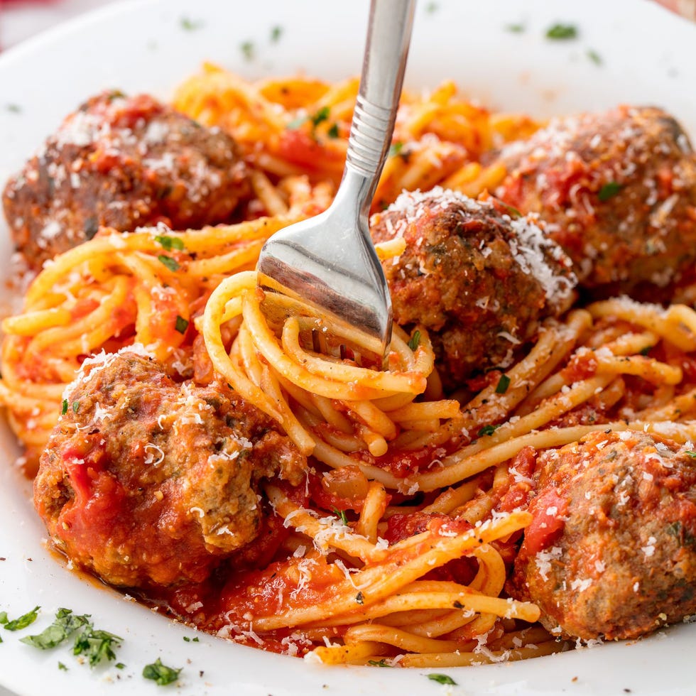 spaghetti and meatballs topped with parmesan